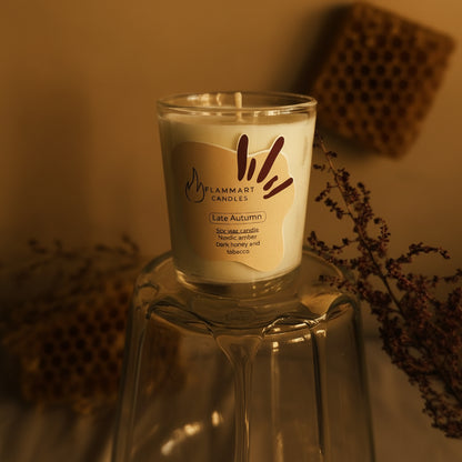 Late Autumn handcrafted soy candle by Flammart featuring Nordic Amber, Tobacco and Dark Honey fragrances in a warm rustic setting
