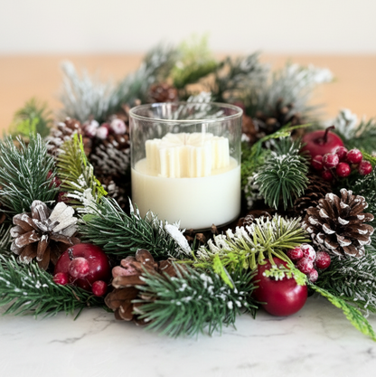 Decorative Christmas wreath with a candle on a marble surface